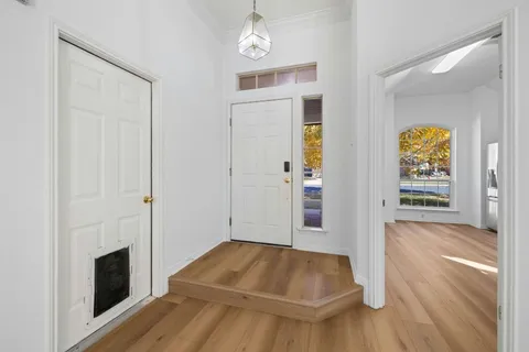 a living room with a fireplace and wooden floor