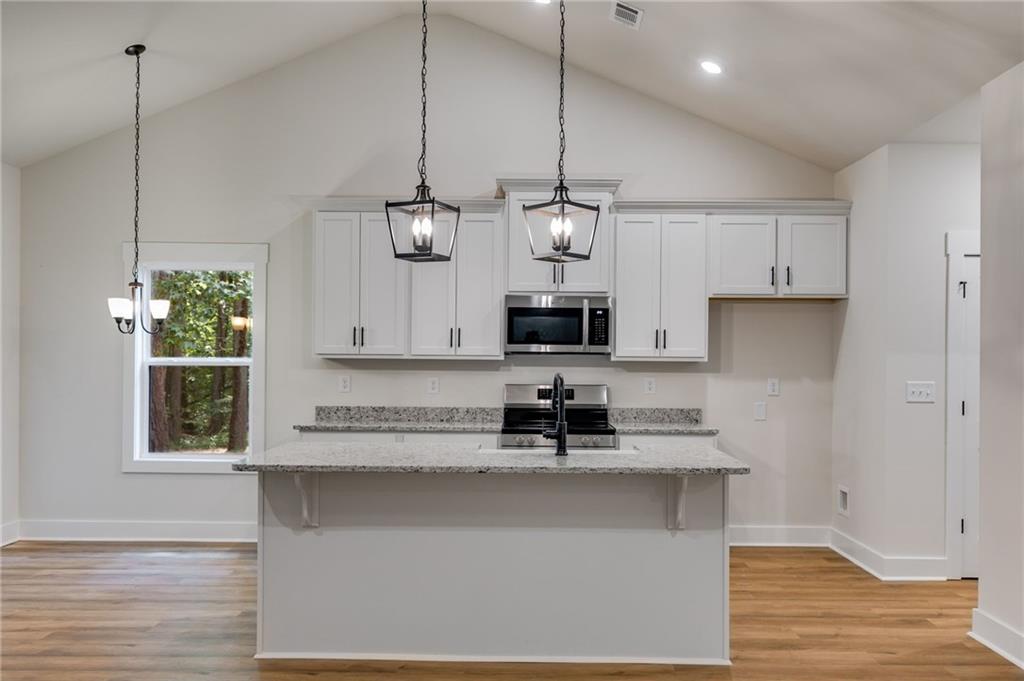 Tract3 Drummond Road Cedartown, GA 30125 - Photo 14 of 41 a kitchen with stainless steel appliances granite countertop a sink a microwave oven a refrigerator and white cabinets