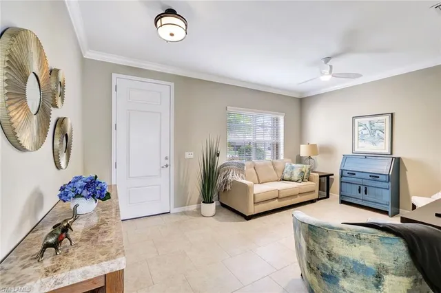 a living room with furniture a chandelier and a window