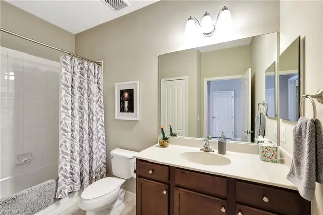 a bathroom with a double vanity sink toilet and shower