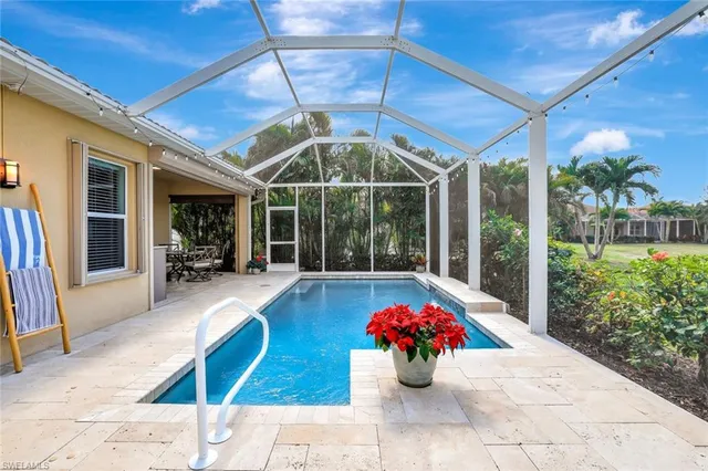 a view of a patio with a table and chairs potted plants