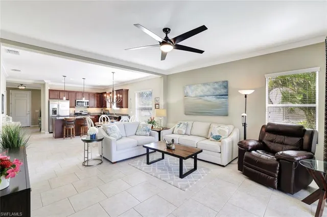 a living room with furniture and a ceiling fan
