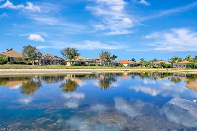 a view of a lake with houses in the back