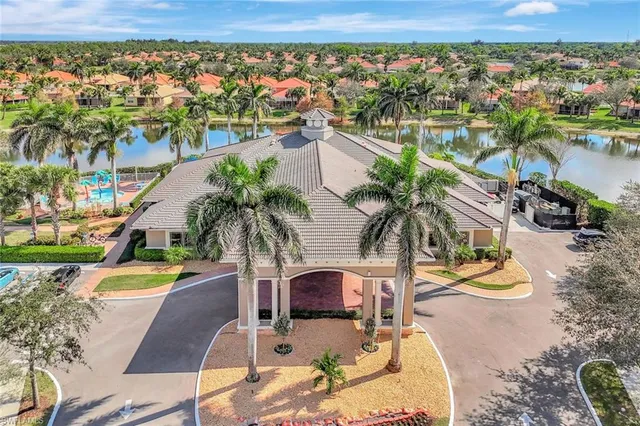 an aerial view of a house with swimming pool and ocean view