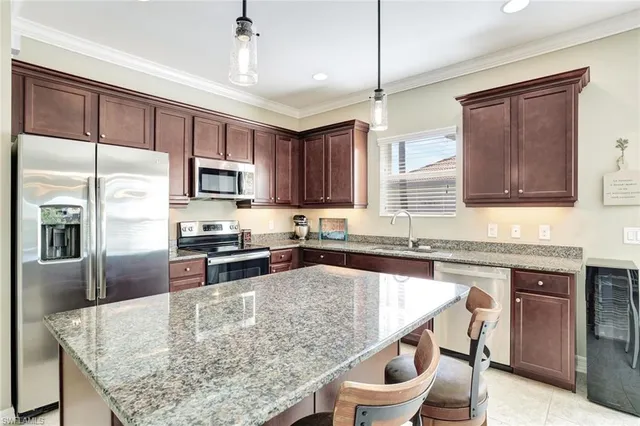 a kitchen with granite countertop lots of counter top space and stainless steel appliances