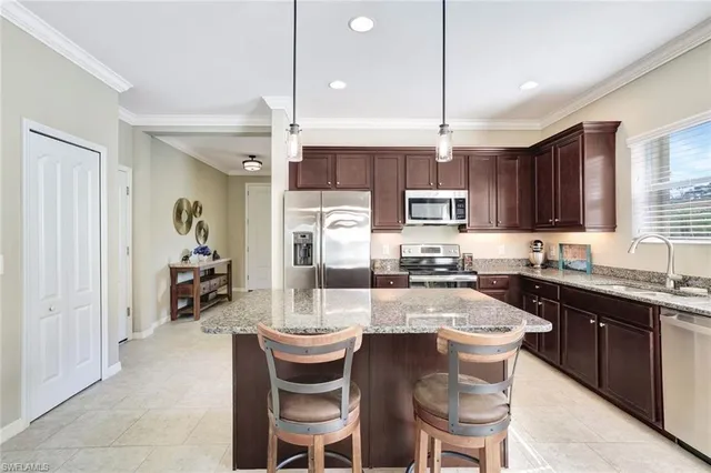 a kitchen with kitchen island granite countertop a sink and counter space