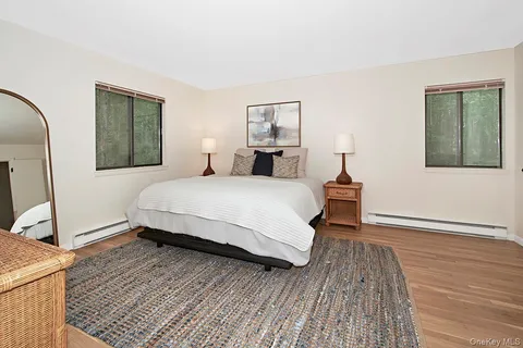 a bedroom with a bed and a mirror