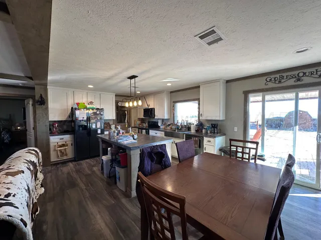 a large kitchen with a table and chairs