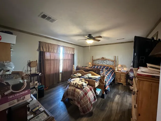 a bedroom with bed and a window