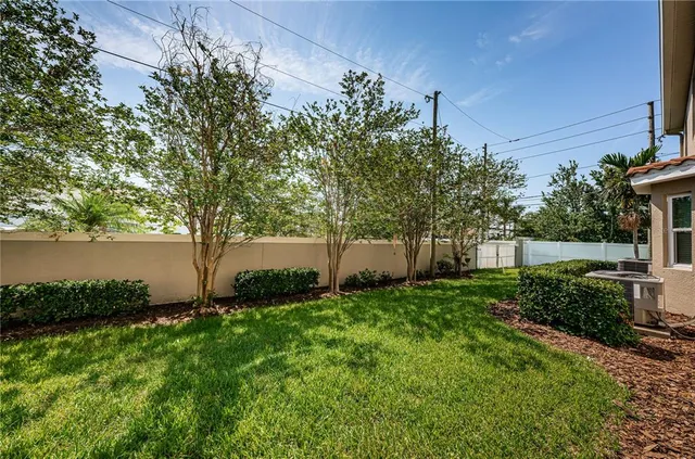 a living room with furniture a large window and stainless steel appliances