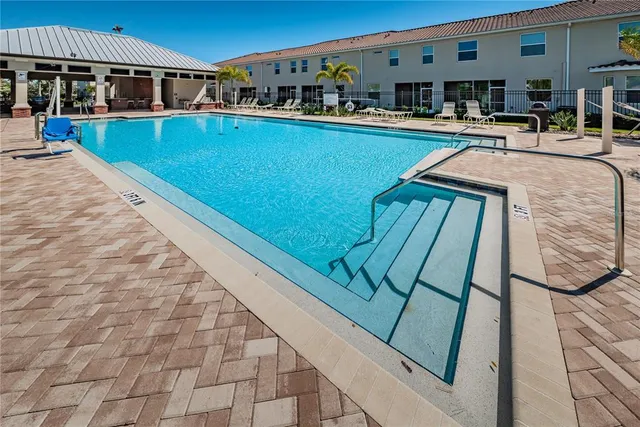 a view of a swimming pool with outdoor seating