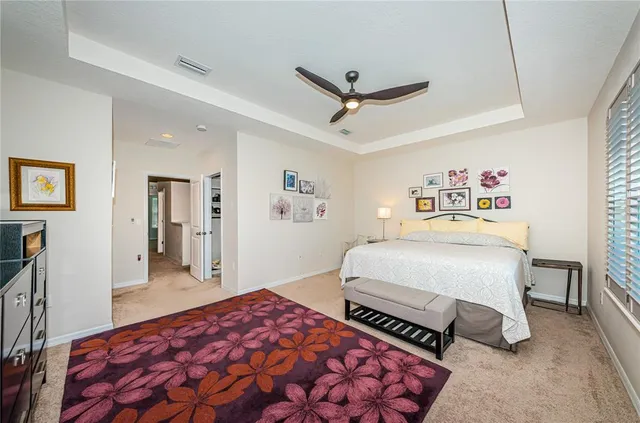 a bedroom with a bed and a television