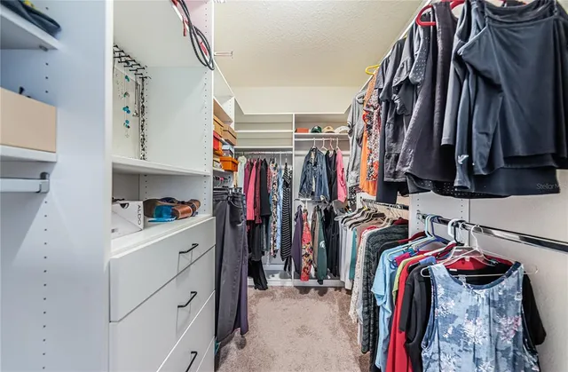 a kitchen with a sink a stove cabinets and a window