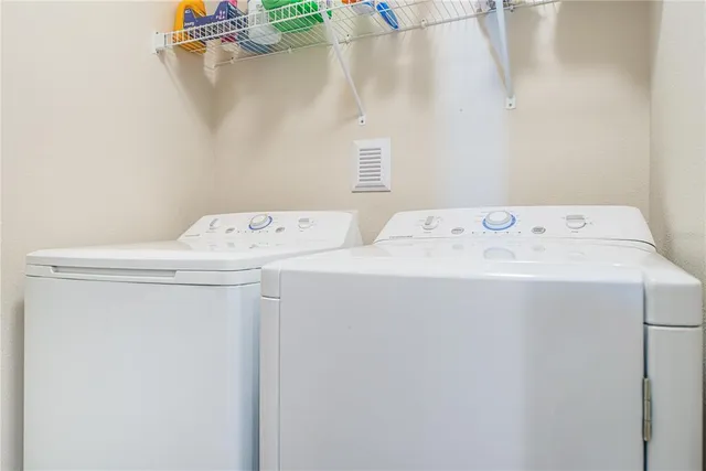 a large kitchen with stainless steel appliances wooden floor and a large window
