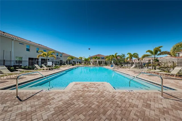 a view of a sign board with buildings in background