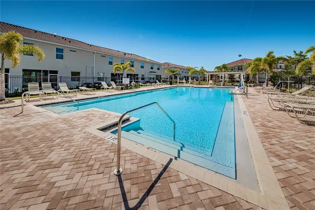 a view of a dining room with furniture and a chandelier