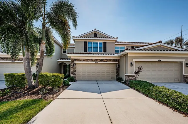 a front view of a house with a yard and garage