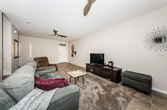 a bedroom with furniture and a flat screen tv