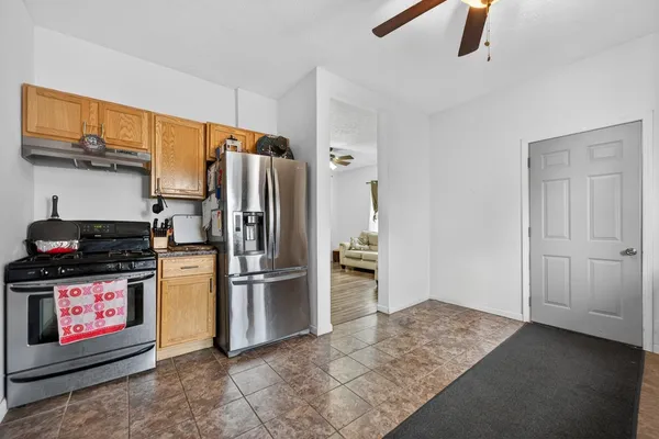 a kitchen with stainless steel appliances granite countertop a refrigerator and a stove