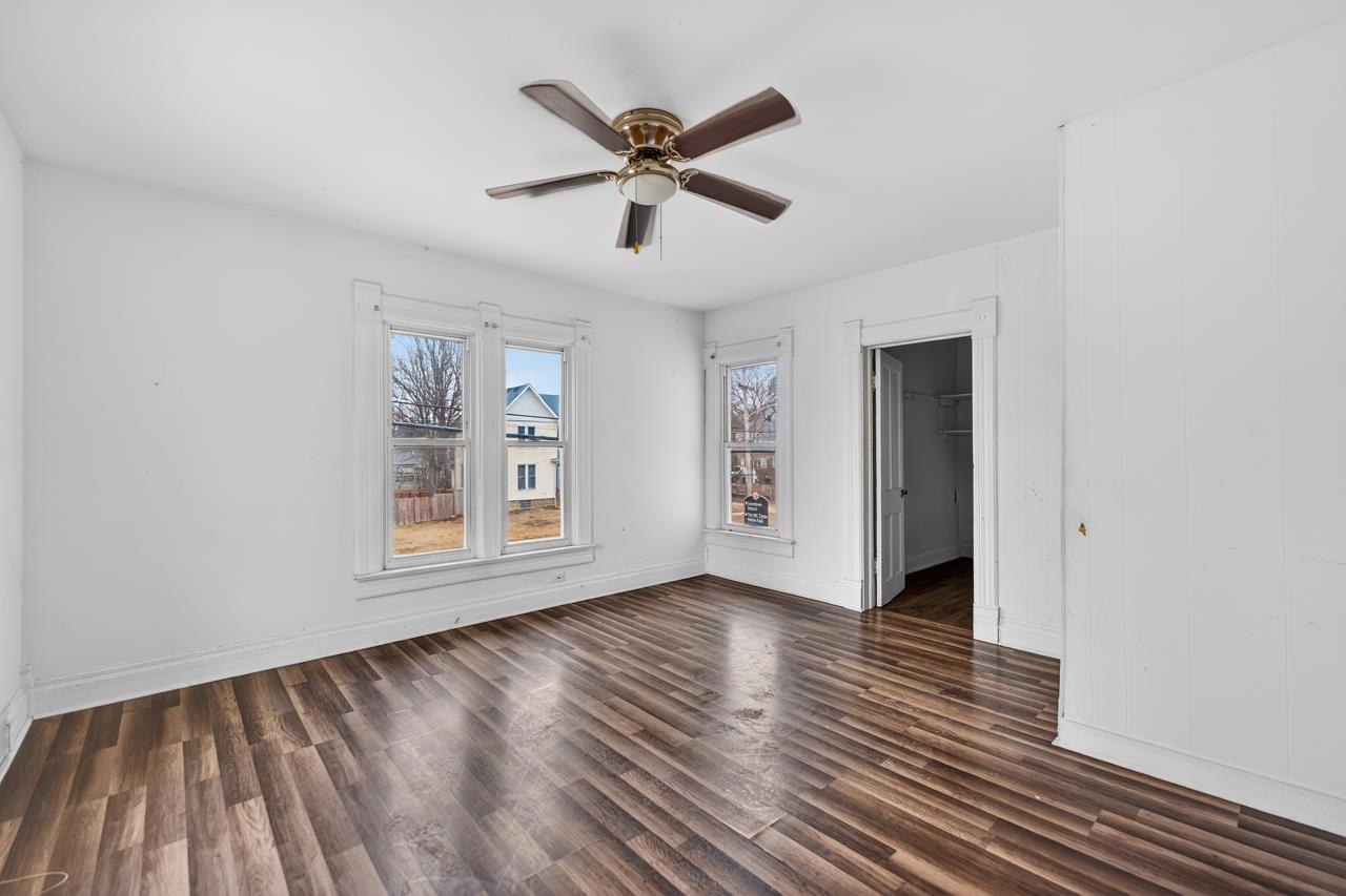 922 Lincoln Avenue Rochelle, IL 61068 - Photo 19 of 46 a view of an empty room with wooden floor and a window