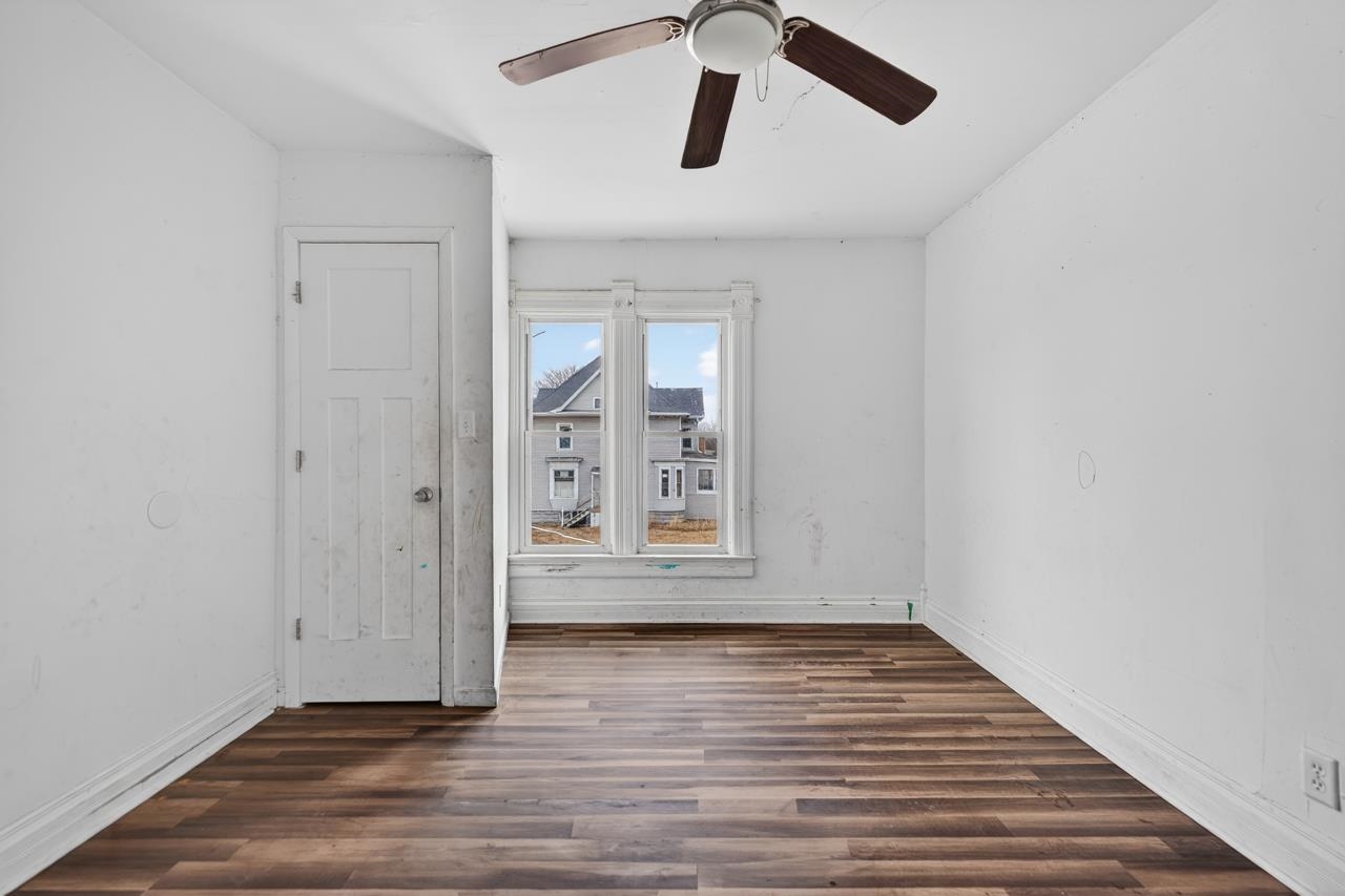 922 Lincoln Avenue Rochelle, IL 61068 - Photo 20 of 46 a view of an empty room with wooden floor and window
