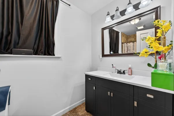 a bathroom with a sink vanity and mirror