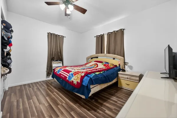 a bedroom with a bed and flat screen tv