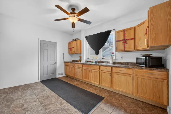 a view of an empty room with wooden floor and window