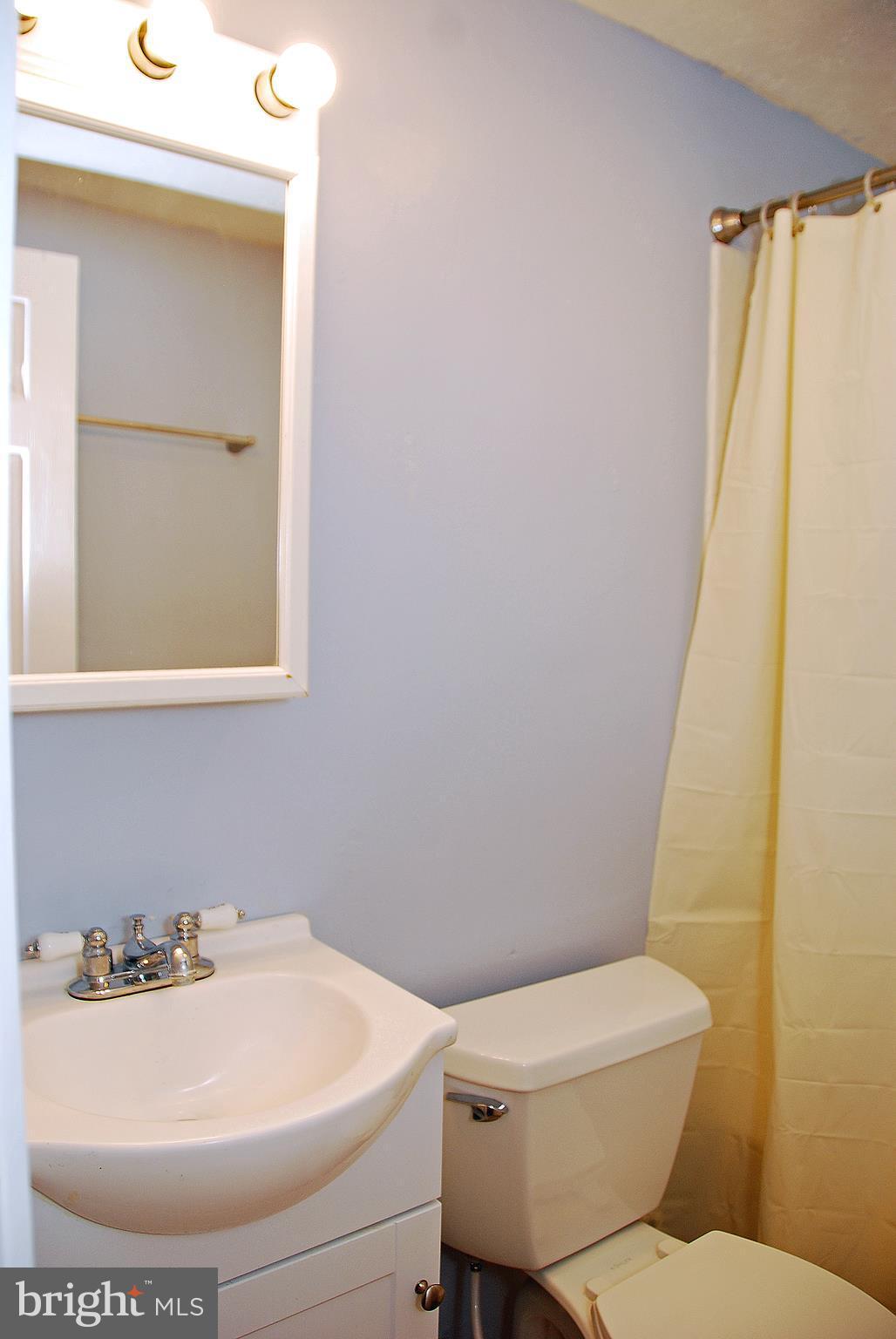 10 Congaree Court Baltimore, MD 21236 - Photo 11 of 22 a white toilet sitting next to a bathroom sink