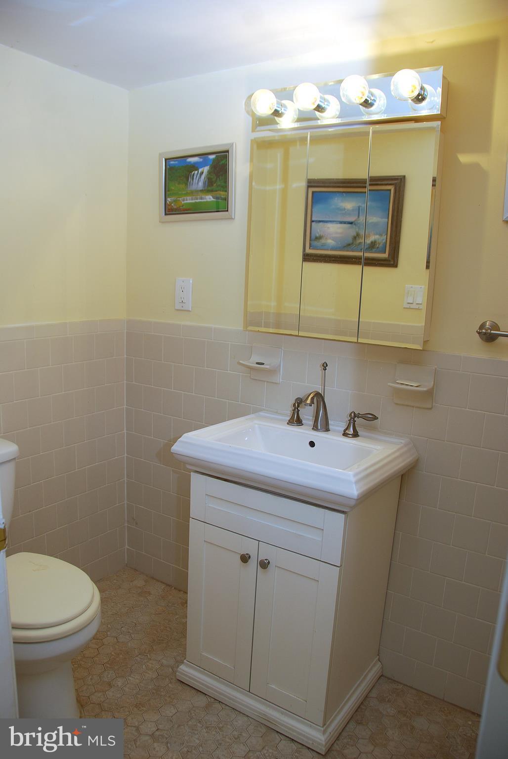 10 Congaree Court Baltimore, MD 21236 - Photo 16 of 22 a bathroom with a toilet sink and mirror