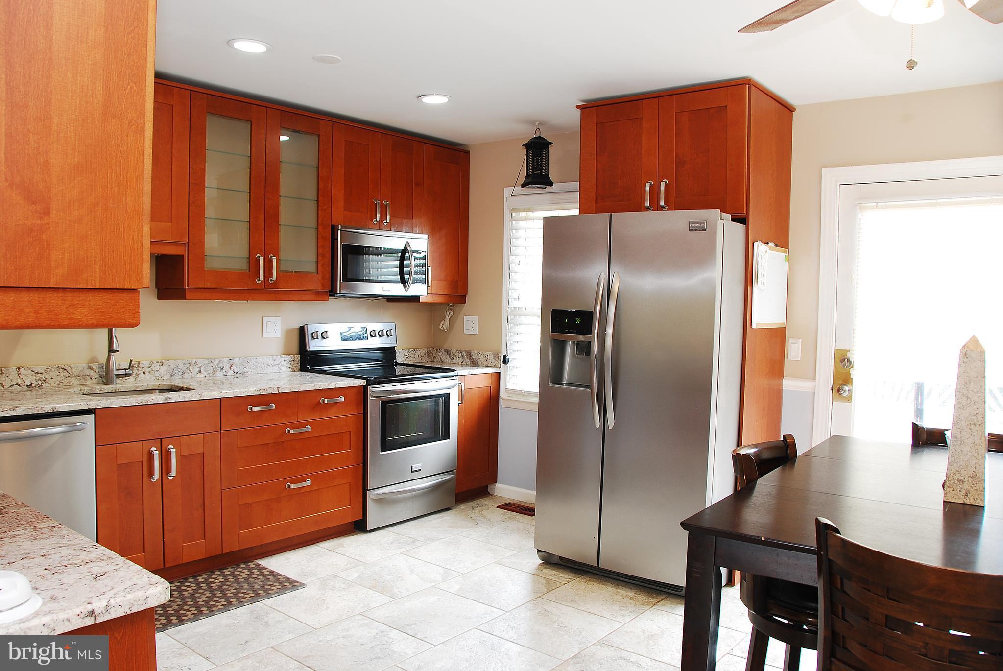 10 Congaree Court Baltimore, MD 21236 - Photo 4 of 22 a kitchen with granite countertop a refrigerator stove top oven and sink
