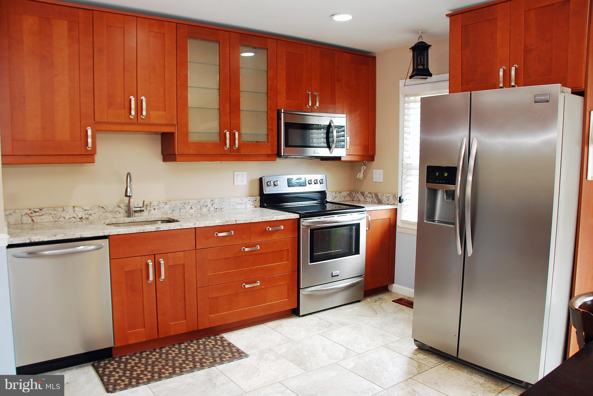 10 Congaree Court Baltimore, MD 21236 - Photo 5 of 22 a kitchen with stainless steel appliances granite countertop a refrigerator stove and sink