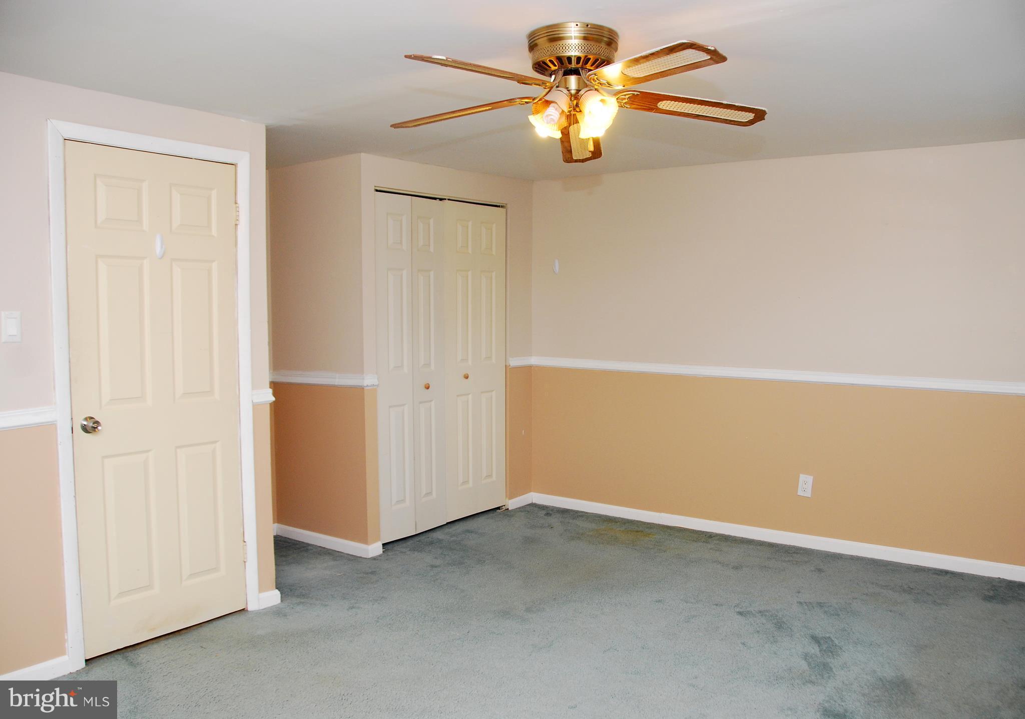 10 Congaree Court Baltimore, MD 21236 - Photo 8 of 22 an empty room with a chandelier fan and a chandelier fan