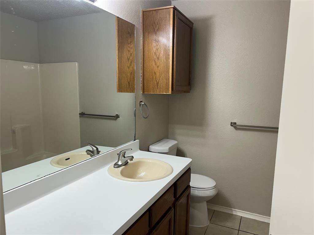 4508 Compass Court Fort Worth, TX 76135 - Photo 17 of 21 a bathroom with a sink toilet and mirror