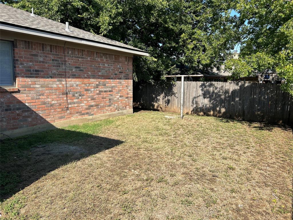 4508 Compass Court Fort Worth, TX 76135 - Photo 21 of 21 a backyard of a house with lots of green space