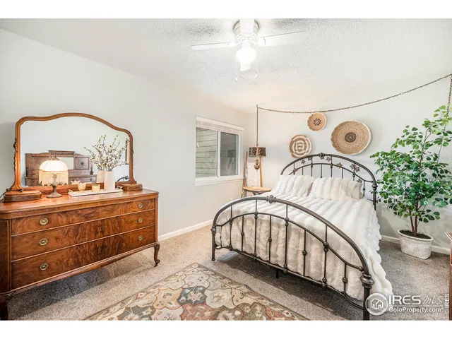 a view of a bedroom with furniture and chandelier