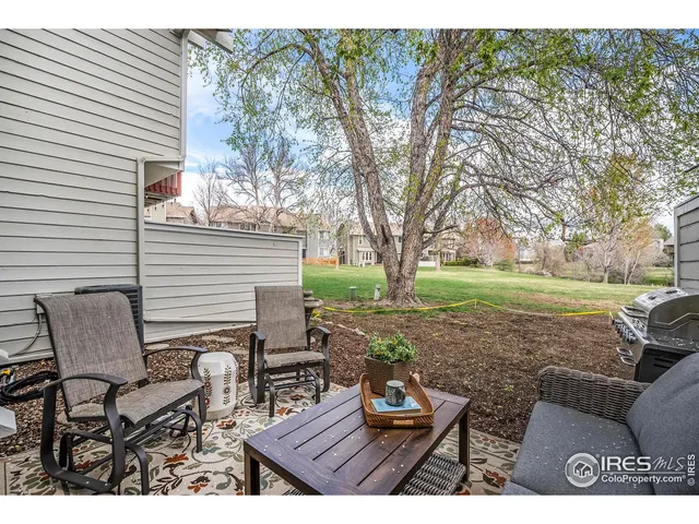 a view of backyard with seating space and trees