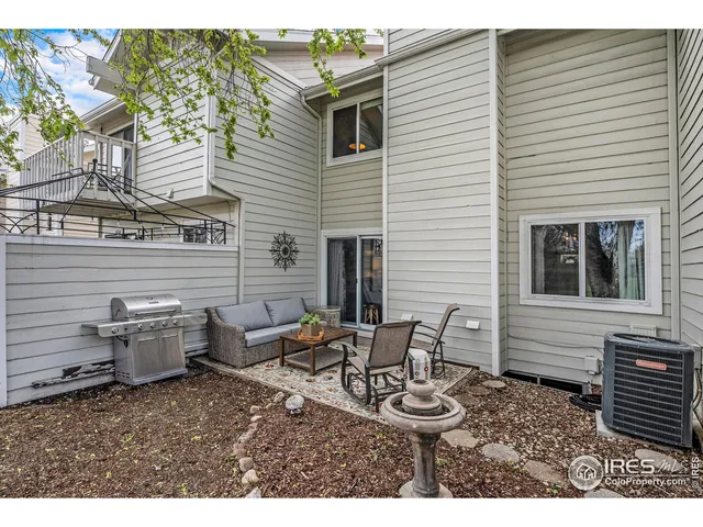 a view of a patio with couple of chairs