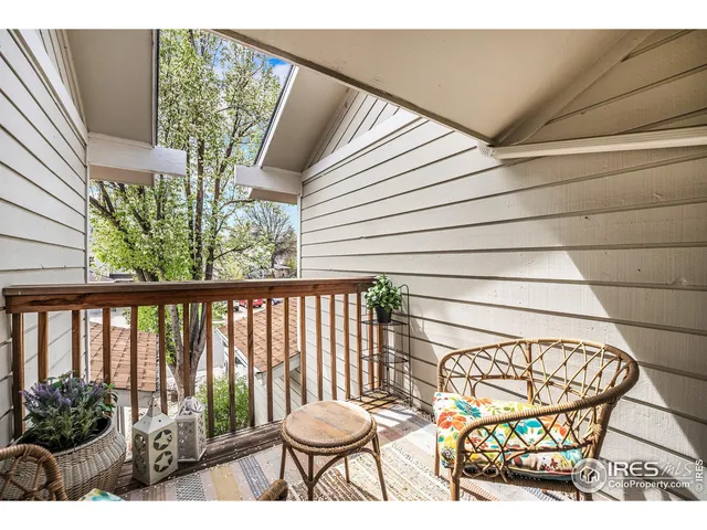 a view of a chairs and table in the balcony