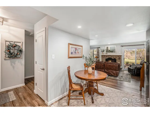 a living room with furniture a table and kitchen view