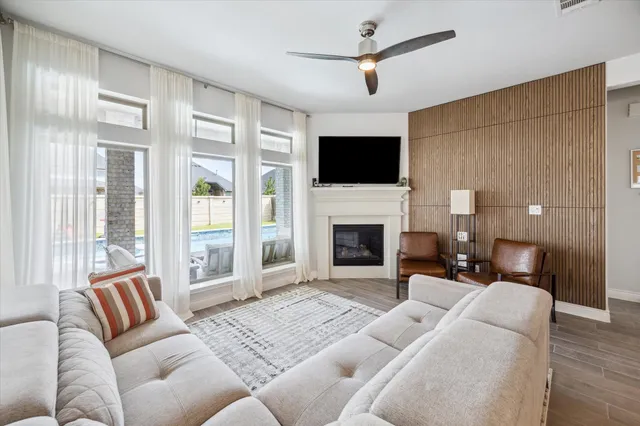 a living room with furniture a fireplace and a flat screen tv