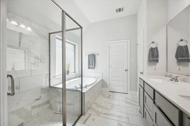 a spacious bathroom with a shower and a sink