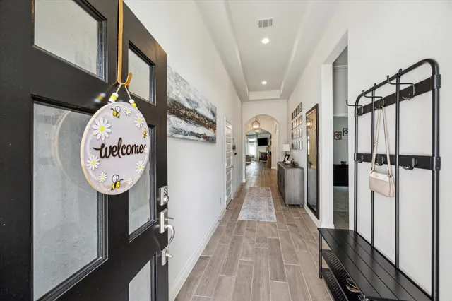 a view of a hallway with wooden floor