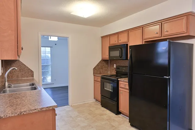 a kitchen with granite countertop stainless steel appliances and wooden cabinets