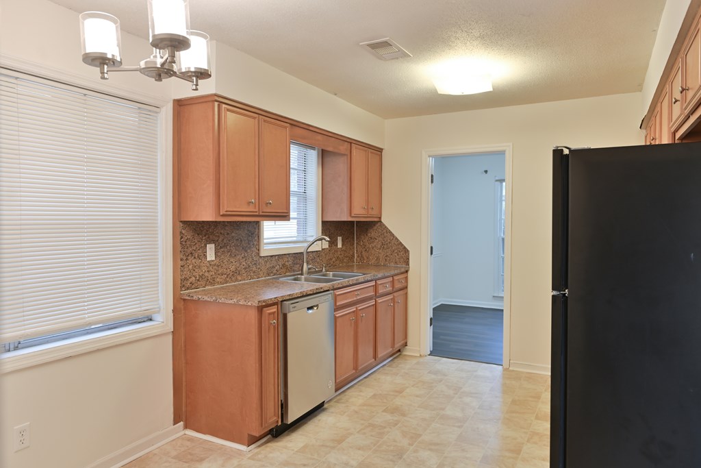 6421 Lemans Lane Columbus, GA 31909 - Photo 16 of 32 a kitchen with stainless steel appliances granite countertop a stove a refrigerator and a sink