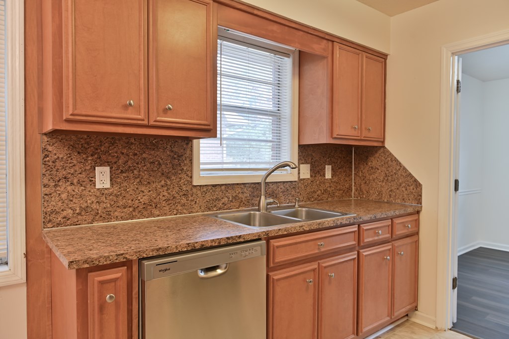 6421 Lemans Lane Columbus, GA 31909 - Photo 17 of 32 a kitchen with granite countertop a sink and cabinets