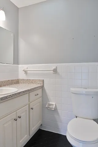 a white toilet and tub sitting next to a bathroom sink