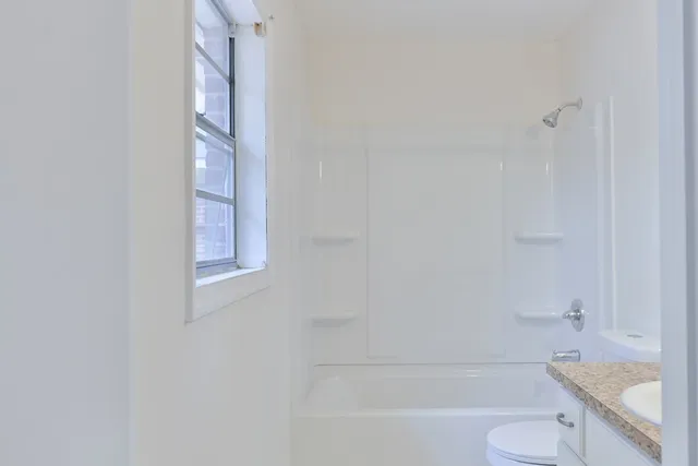 a bathroom with a toilet and a bathtub