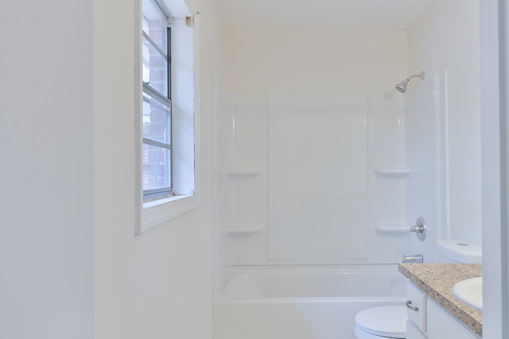 6421 Lemans Lane Columbus, GA 31909 - Photo 31 of 32 a bathroom with a granite countertop bathtub shower sink vanity and toilet