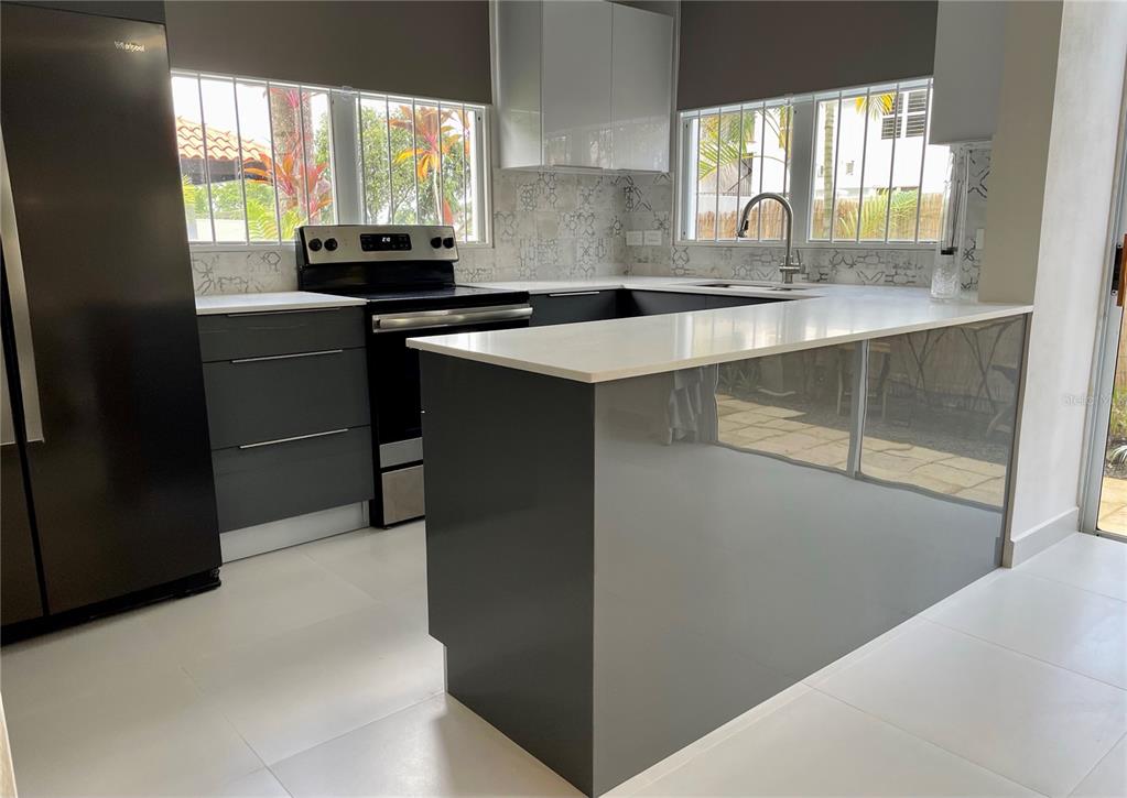 290 Av. Sta. Ana Guaynabo, Bayamón 00969 - Photo 8 of 23 a kitchen with kitchen island a sink appliances cabinets and a counter top space